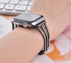 a woman's arm with an apple watch on it and a keyboard in the background