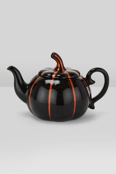 a black tea pot with orange stripes on it