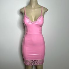 a mannequin wearing a pink dress with lace trim