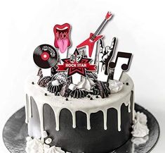 a black and white cake topped with lots of music symbols on top of it's icing