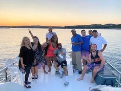 a group of people standing on top of a boat