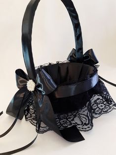 a black lace basket with a bow on it