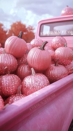 a truck filled with lots of pink pumpkins