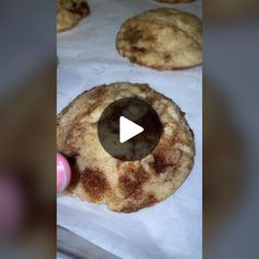 an image of some cookies being made on the table with a video play button in front of them