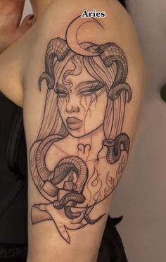 a woman's arm with a tattoo on it and the words aries above her