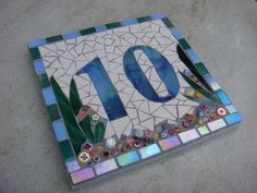 a mosaic tile with the number ten on it