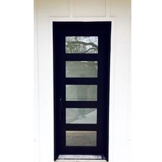 a black front door with glass panels on the side