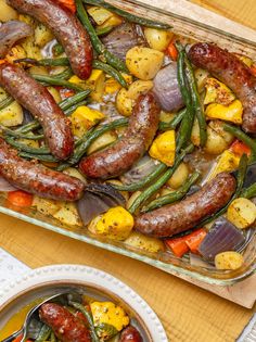 sausages, potatoes and green beans in a casserole dish