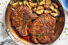 two steaks and potatoes in a skillet