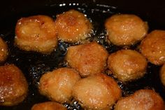 fried meatballs are being cooked in a frying pan