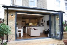 an open living room and dining area with sliding glass doors