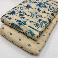 two pieces of blue and white fabric sitting on top of each other in front of a white background