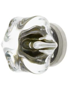 a glass door knob with an artistic design on the front and back of it's handle