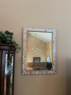 a mirror hanging on the side of a wall