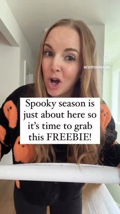 a woman holding up a sign that says spooky season is just about here so it's time to grab this freebie