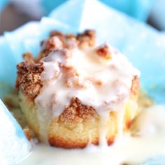 a close up of a piece of cake on a plate with icing and crumbs