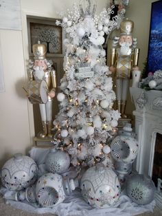 a white christmas tree surrounded by ornaments