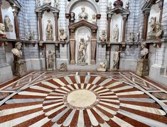 an intricately designed room with statues on the walls