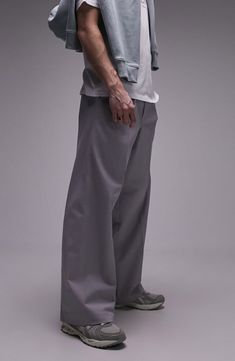 Go for a relaxed fit with your next smart-casual look in these baggy pants cut from a crisp cotton with a hint of stretch. 32" inseam; 20" leg opening; 13" front rise; 16" back rise (size 32) Back elastic waist Side-seam pockets 98% cotton, 2% elastane Machine wash, line dry Imported Baggy Solid Color Straight Leg Dress Pants, Relaxed Fit Wide Leg Pants With Welt Pockets, Baggy Cotton Wide-leg Bottoms, Baggy Straight Leg Dress Pants, Wide Leg Pants With Welt Pockets And Relaxed Fit, Fall Baggy Straight Leg Dress Pants, Wide Leg Leather Pants For Streetwear, Classic Cargo Pants For Streetwear With Straight Hem, Classic Cargo Pants With Straight Hem For Streetwear