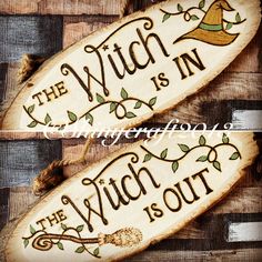 two wooden signs that say the witch is in and the witch is out