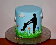 a blue cake with a silhouette of a man holding a child