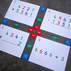 four pieces of paper with numbers on them sitting on the ground next to each other