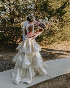 a woman in a wedding dress holding a bouquet