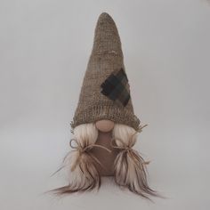 a doll with long blonde hair wearing a burlocked hat on top of it's head