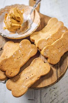 dog biscuits and peanut butter on a wooden plate