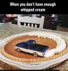 a blue pickup truck on top of a pie crust in the shape of a circle