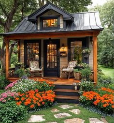 a small house with flowers in the front yard