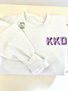 "This Kids monogrammed sweatshirt is perfect all season long for those cold days!  These are unisex sweatshirts and pricing includes the cover/stitch backing. Sizing runs true to size.  YS is 5/6, YM is 7/8, YL is 8/10, toddler and adult sizes available too.  Youth & Toddler sweatshirt colors Navy, White, Hot Pink, Pink, Baby Blue, Black, Purple, Red, Orange, Grey, Hunter Green (message me for other colors not listed) Listing includes embroidery personalization up to 3 characters and will be the Kids Embroidered Sweatshirt, Personalized Cotton Sweatshirt For Winter, Personalized Relaxed Fit Winter Sweatshirt, White Personalized Crew Neck Sweatshirt, Personalized White Crew Neck Sweatshirt, Personalized Crew Neck Sweatshirt For Fall, Personalized Cotton Sweatshirt For Fall, Cotton Monogram Sweatshirt, Cotton Monogram Long Sleeve Sweatshirt