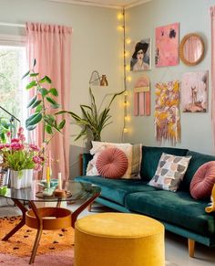 a living room filled with furniture and lots of plants