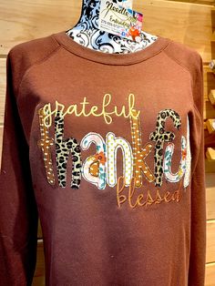 Thankful Grateful $ Blessed Custom Embroidered Thanksgiving Fall Shirt. This is done as vintage, raw edge  Embroidered Appliqué that will fray a little with each wash.  Fabrics are Fall multi colored fabrics however you can choose the color you want & a fabric color theme in single or multiple.  This is available in Long sleeve T, Sweatshirt, or a raglan shirt.   This is also available on reg Gildan styles or Comfort Colors, Hanes Comfort Wash.  Each shirt is unique as fabrics may vary depending on availability. Shirts run true to size of a unisex.  This can be done in your choice of theme colors.  The raw edge will allow the fabrics to fray a little with each wash giving it a vintage look. Please allow 2 weeks to complete.  If you need sooner please msg. Custom made so no refunds Merry Christmas Shirts, Grateful Thankful Blessed, Raglan Shirts, Thanksgiving Shirts, Pretty Design, Embroidered Shirt, Fall Shirts, Christmas Shirts, Vintage Looks