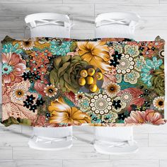 two toilet paper rolls sitting next to each other on top of a wooden floor covered in flowers