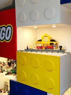 legos are stacked on top of each other in a room with white walls and ceilings