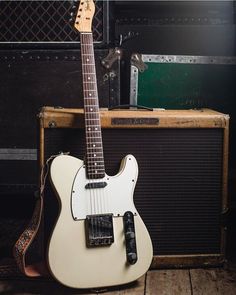 an electric guitar sitting on top of a wooden floor