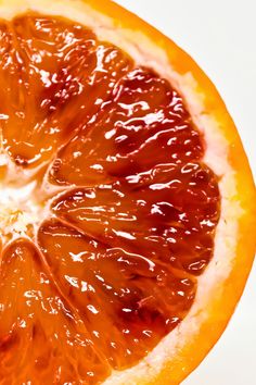 an orange cut in half on a white surface