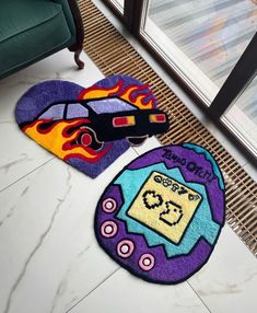 two rugs with cars on them sitting next to each other in front of a window