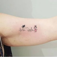 a woman's arm with a heartbeat tattoo on it