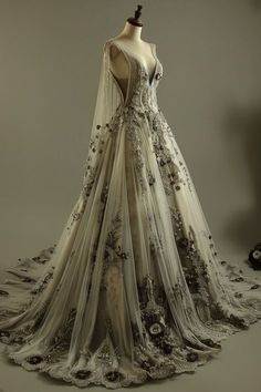 a wedding dress on display in front of a mannequin's headdress