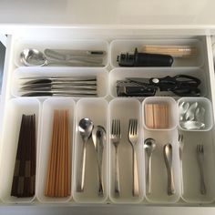 an organized drawer with utensils and spoons