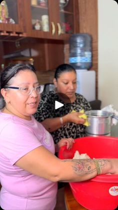 two women in the kitchen preparing food together