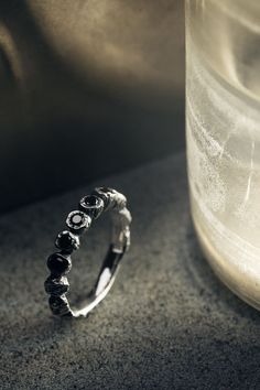 Thin, raw band inspired by the crowns featuring six natural 'black sapphires' sourced in Sri Lanka. Perfect fit for stacking with other rings. Hand carved and finished using artisan techniques. Oxidized and polished for texture enhancement. Made of .925 sterling silver Weight approx. 16g /// #gonearchive #menrings #mensrings #mensjewelry #ringforman #jewelryformen #mensfashion #menjewelry #artisanjewllery #handcraftedjewelry #silverrings