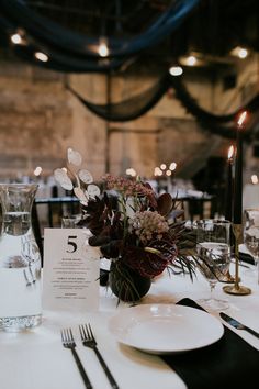 the table is set with white plates and silverware