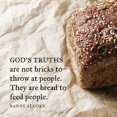 a loaf of bread sitting on top of a piece of paper with a quote about god's truth