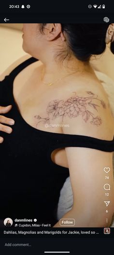 a woman with a flower tattoo on her shoulder and chest is looking at the camera