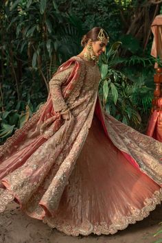 a woman in a pink and gold wedding gown