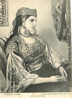 an old black and white photo of a woman in traditional dress sitting on a chair