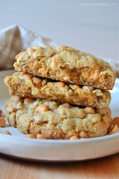 three oatmeal cookies stacked on top of each other in a white plate